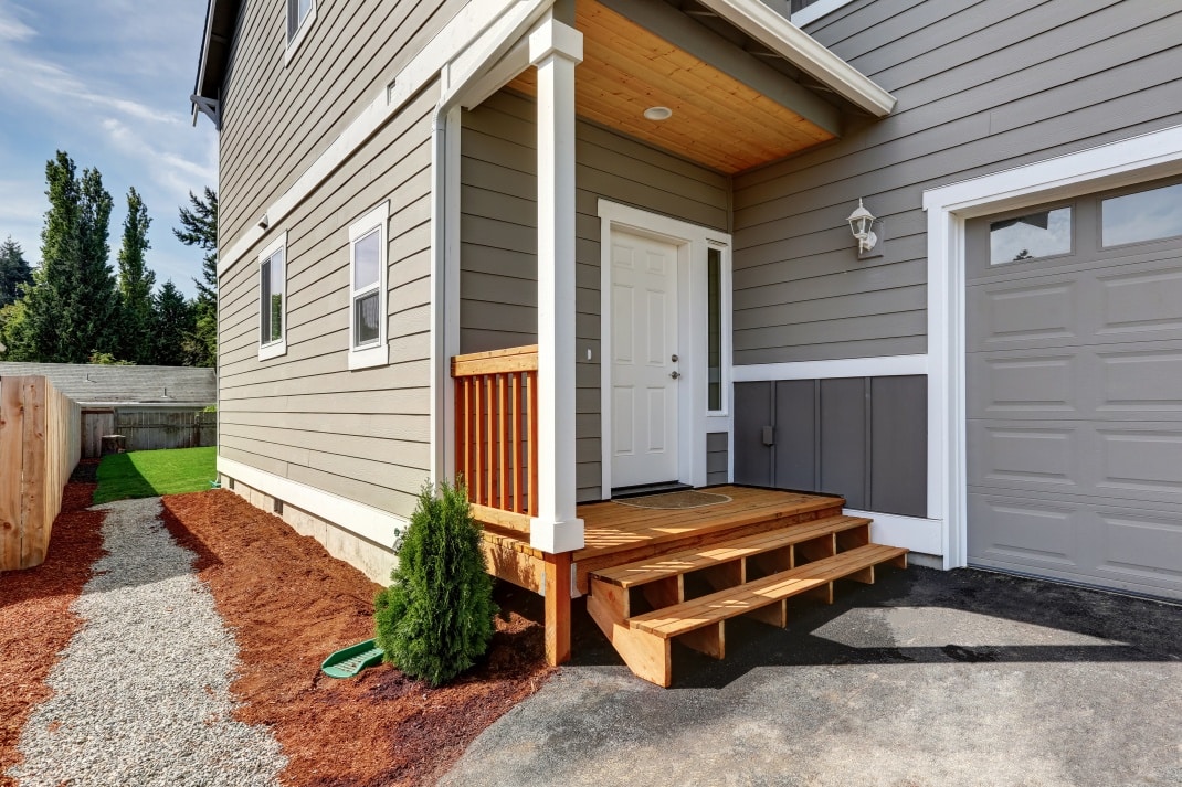 Hauseingang mit niedriger  breiter Holztreppe © Shutterstock.com - Artazum