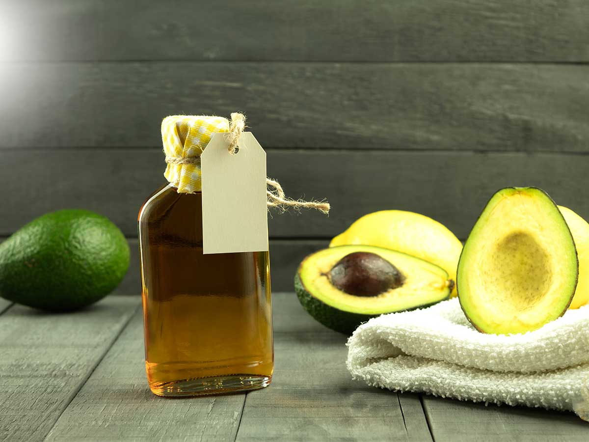 Avocado-Hälften und Ölflasche